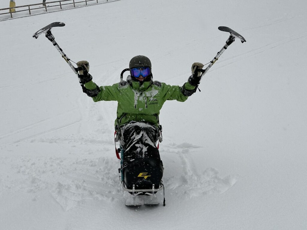 Azul-Sky posing while skiing in a sit ski