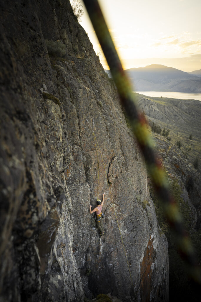 Azul-Sky climbing up the side of a cliff overlooking Kamloops Lake